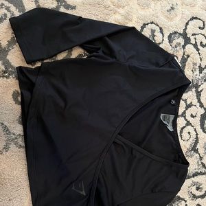 Black gymshark cropped sleeve with cross front. Cropped, very soft. Small ☺️